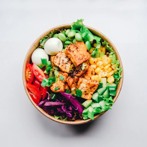 A plant-based grain bowl with vegetables and tofu