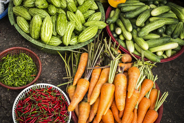 An overhead spread of raw vegetables in bowls